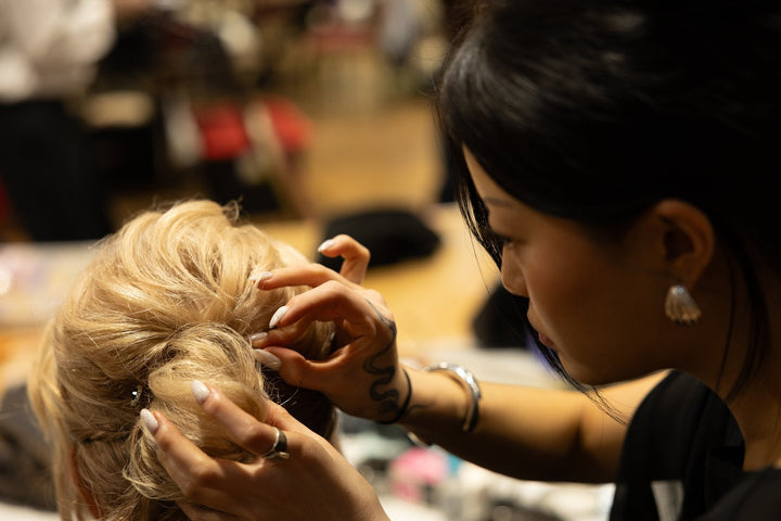 Studio Booth stylist finishing a runway look backstage at It's About Time, the 2026 Pittsburgh Opera Fashion Show (photo: Dave Hochendoner)